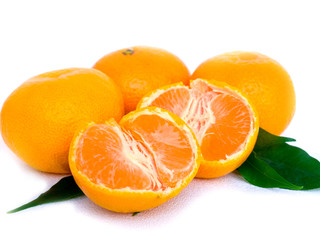 Tangerines with leaves and slices on white background