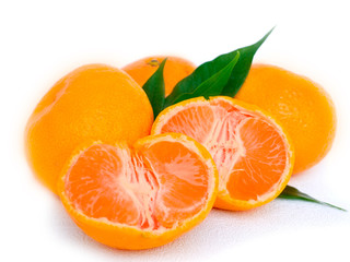Tangerines with leaves and slices on white background
