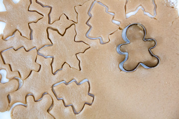 Christmas cookies. Baking . Roll out the dough to cut stars on a wooden background