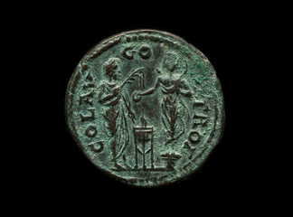 Round ancient copper coin with two figures on it