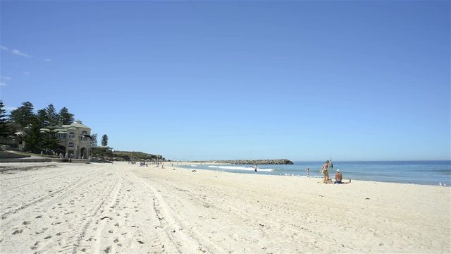 Cottesloe Beach in Perth, Western Australia, on a quiet summer day, with people enjoying the popular beach to escape the heat.
