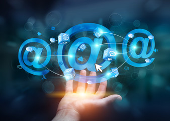 Businessman holding 3D rendering email icon in his hand