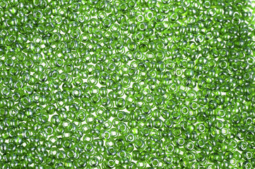 Green glass beads background - closeup beads texture