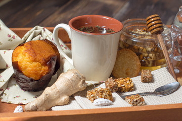 breakfast in bed include tea, cookies, cupcake, honey and sweets