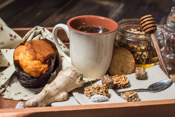 breakfast in bed include tea, cookies, cupcake, honey and sweets