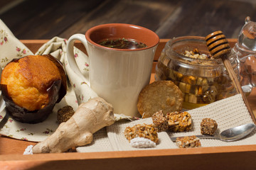 breakfast in bed include tea, cookies, cupcake, honey and sweets