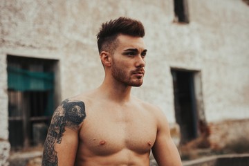 Attractive guy with showing his muscles