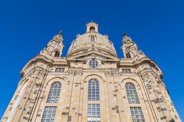 Fototapeta premium Famous Frauenkirche in the city center of Dresden, Germany in the morning sun with blue sky above.