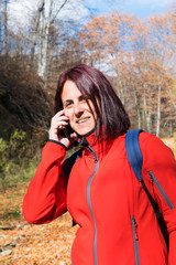 Woman using her mobile phone while hiking