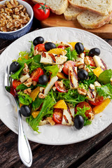 Grilled Halloumi Cheese salad witch orange, tomatoes and lettuce. healthy food