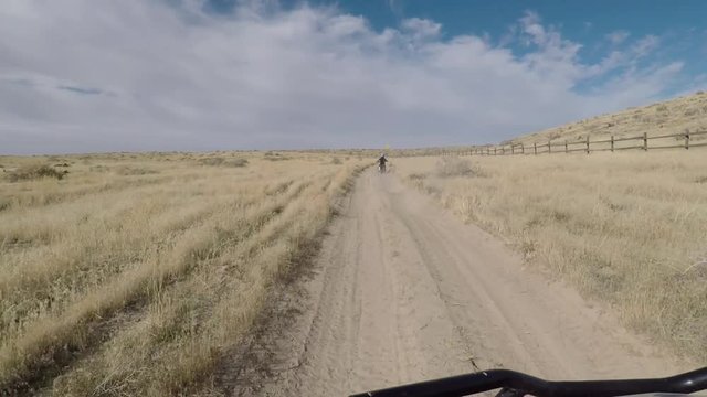 Recreation 4x4 offroad follow motorcycle desert POV. Exploring high mountain and valley roads and trails. Riding sports utility vehicle UTV side by side 4x4 4 wheel drive ATV. Outdoors and landscape.
