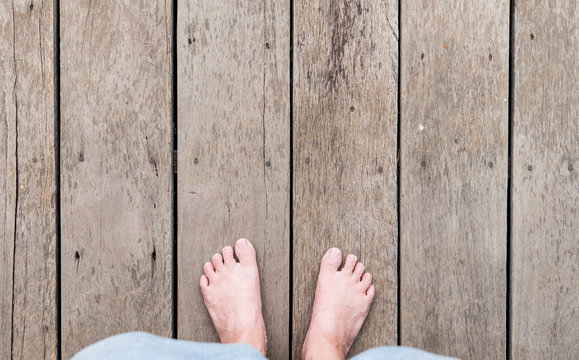 aerial view of barefoot with short pants stand on grunge wood pl