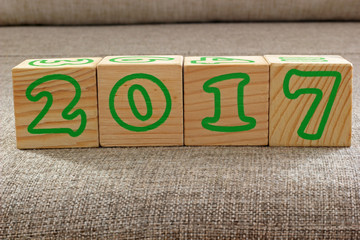 Fototapeta premium Merry Christmas and Happy New Year 2017. Wooden cubes with the numbers 2017 on the sack fabric.