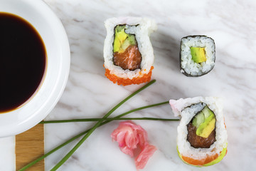 Delicious mixed sushi arranged on white marble surface
