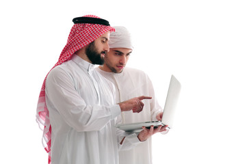 Two Arabian Businessmen Analyzing results holding a laptop over a white background, business concept