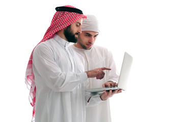 Two Arabian Businessmen Analyzing results holding a laptop over a white background, business concept