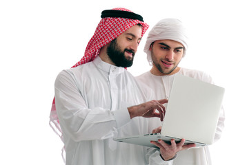 Two Arabian Businessmen Analyzing results holding a laptop over a white background, business concept