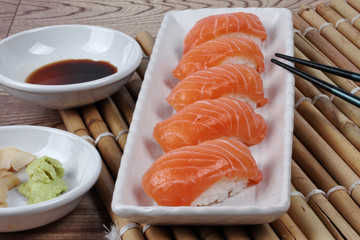 Close up - salmon sushi served with side dish. Selective focus