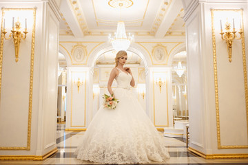 beautiful young woman bride in luxury wedding dress in interior