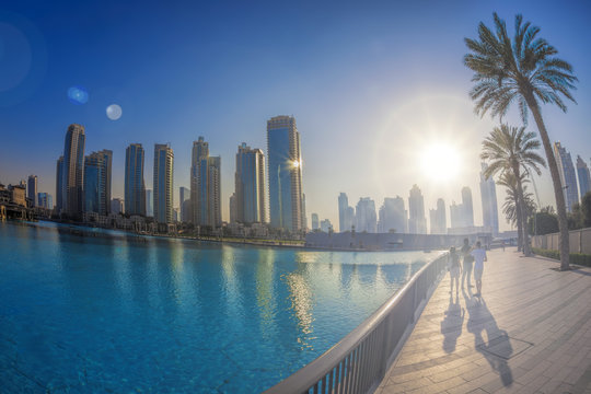 Dubai lagoon with skyscrapers against sunset in UAE
