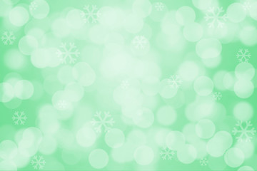 Snowflakes and bokeh light on green background