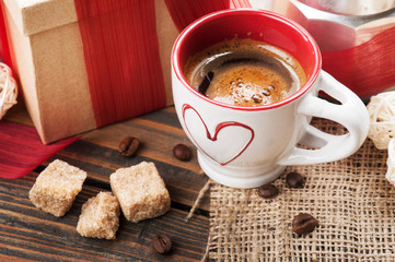 cup of coffee, gift with red ribbon, brown sugar