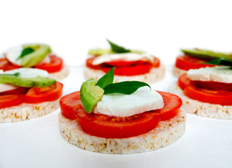 Healthy food - sandwiches, rice crackers with tomato, avocado and mozzarella cheese
