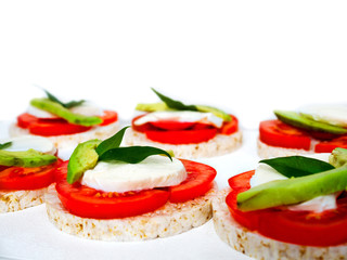 Healthy food - sandwiches, rice crackers with tomato, avocado and mozzarella cheese