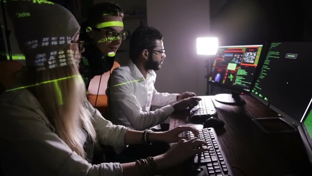 Group of hacker using computer code in dark. HD.