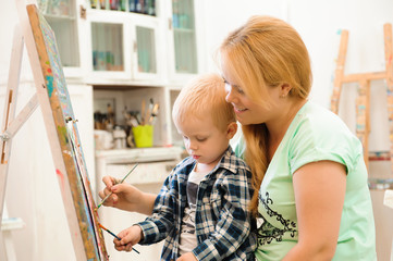Mother and child draw a picture paints, art lesson