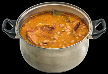 Beans With Smoked Pork Ribs Baked In Old Stainless Steel Saucepot Isolated On Black Background