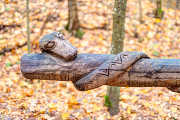 Old wooden sculptures in the forest. Witch Hill park, Lithuania.