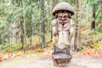 Old wooden sculptures in the forest. Witch Hill park, Lithuania.