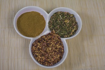 Assorted spices in white bowls