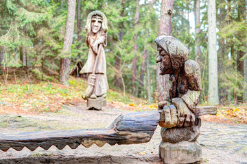 Fototapeta na wymiar Old wooden sculptures in the forest. Witch Hill park, Lithuania.