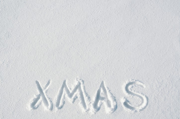 Xmas letters handdrawn on flat snow surface. Nice horizontal holiday postcard, greeting card template. Empty space for copy, text, lettering.