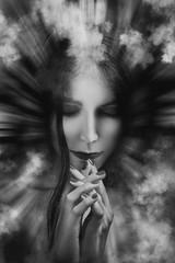 sad woman praying in clouds and light rays, monochrome