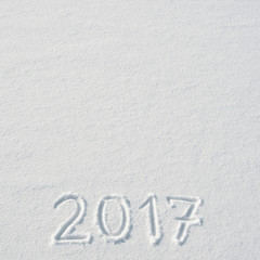 2017 numbers handwritten on flat snow surface. Empty space for copy, text, lettering. New year holiday postcard, greeting card template.