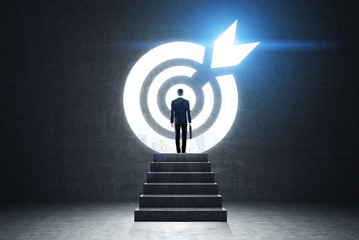 Businessman near a blue target