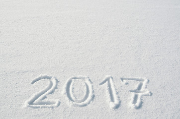 2017 numbers handwritten on flat snow surface. Empty space for copy, text, lettering. New year holiday postcard, greeting card template.
