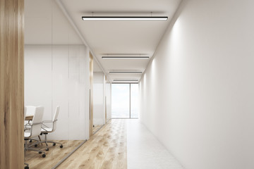 Front veiw of office with blank wall and row of meeting rooms