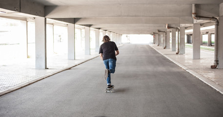 Fototapeta na wymiar Professional skateboarder in underground passage