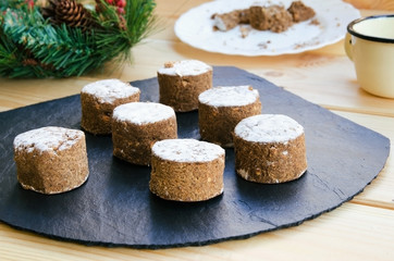 Polvorones, typical  Christmas sweets  in Spain on black stone background. Polvoron is a shortbread cookie / candy.