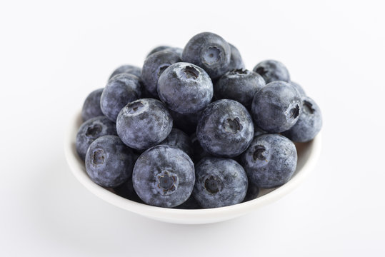 Group of fresh juicy blueberries on white background