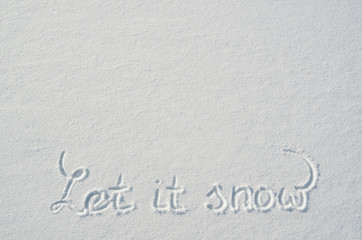 Beautiful let it snow letters calligraphy handdrawn on flat snow surface. Nice Christmas holiday square postcard, greeting card template. Empty space for copy, text, lettering.