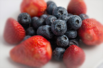 Fresh strawberries and blueberries on white background