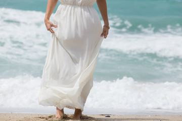 Fototapeta na wymiar woman in white dress on beach