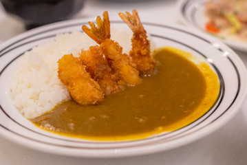 Deep Fried Shrimp with Japanese curry on rice in restaurant.