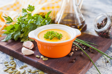 pumpkin cream soup in a bowl on a table, selective focus