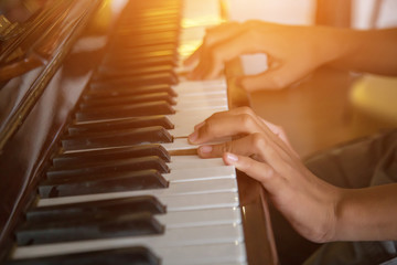 Musician playing piano with vintage filter.